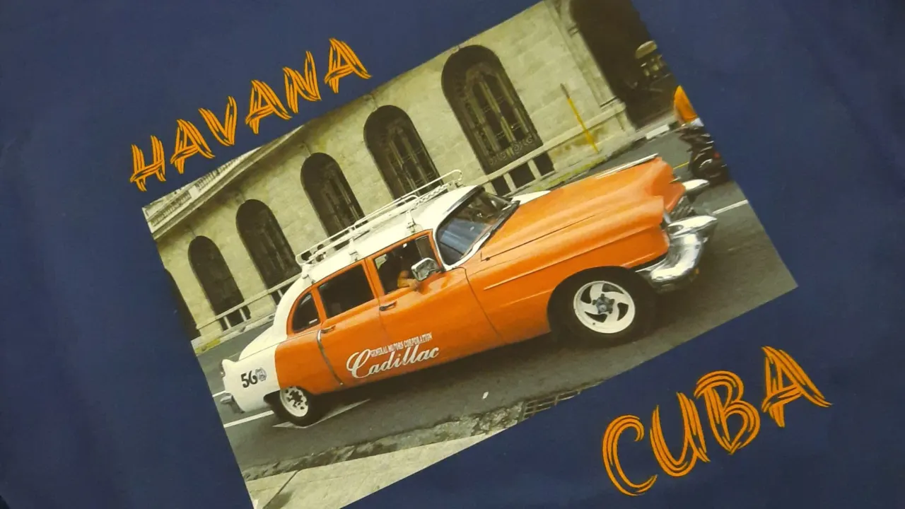 Blue t-shirt printed with a full colour photo of an orange classic car and the words Havana Cuba